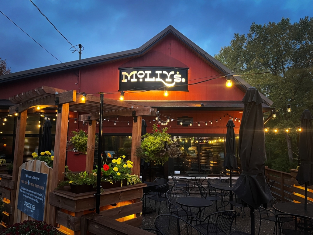 Molly's in St Boni Outdoor Patio photo taken at dusk showing seating and lights